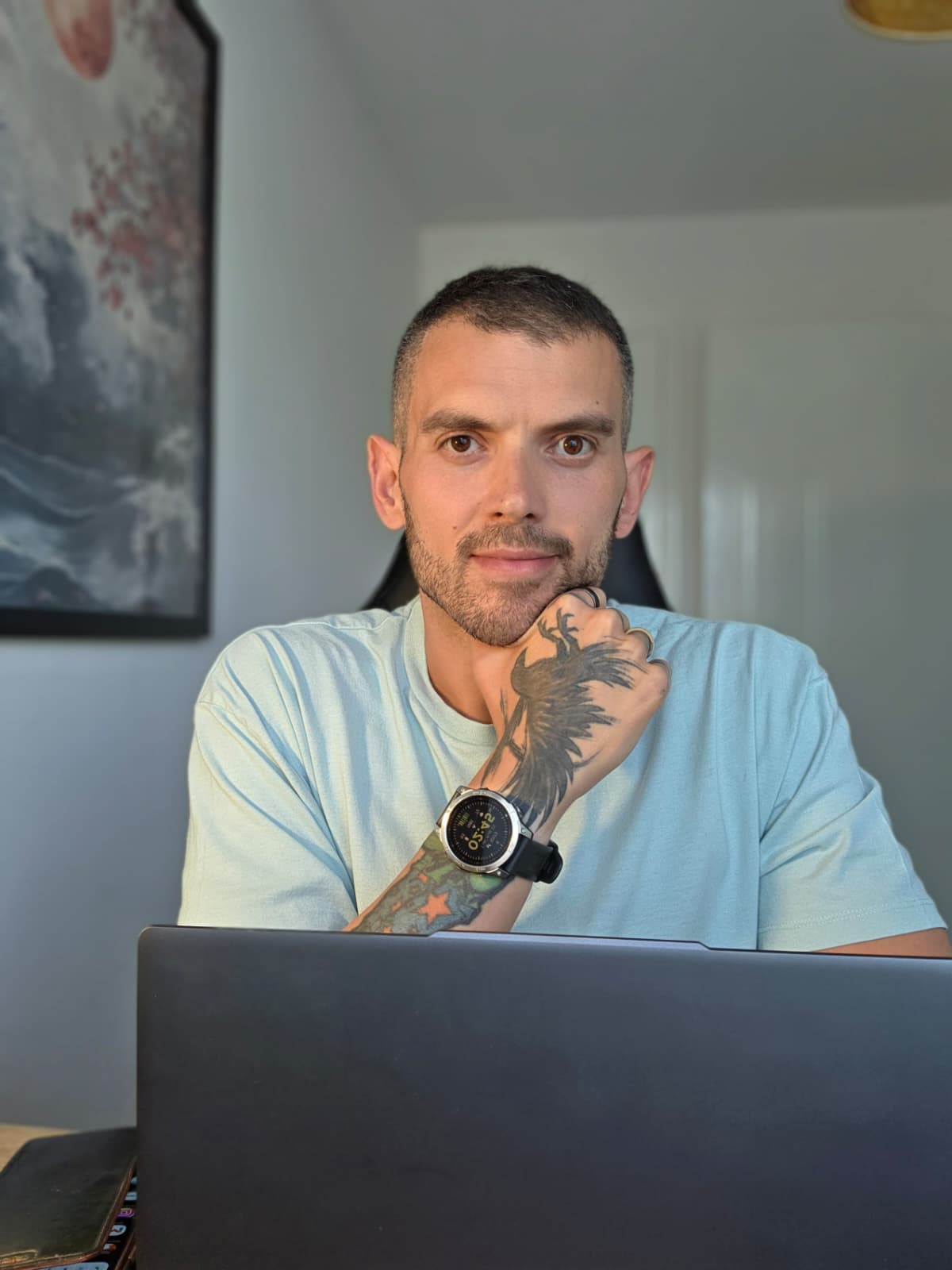 Carl at his desk, seated behind his laptop